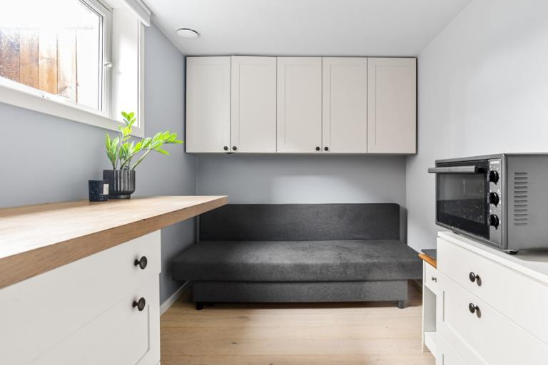 Compact interior with cabinetry integrated into the room rather than added as separate storage furniture