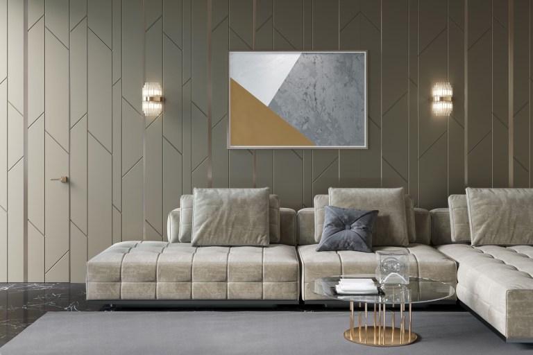 A moody, richly paneled living room lit by twin wall sconces flanking an abstract painting above a plush sectional sofa.