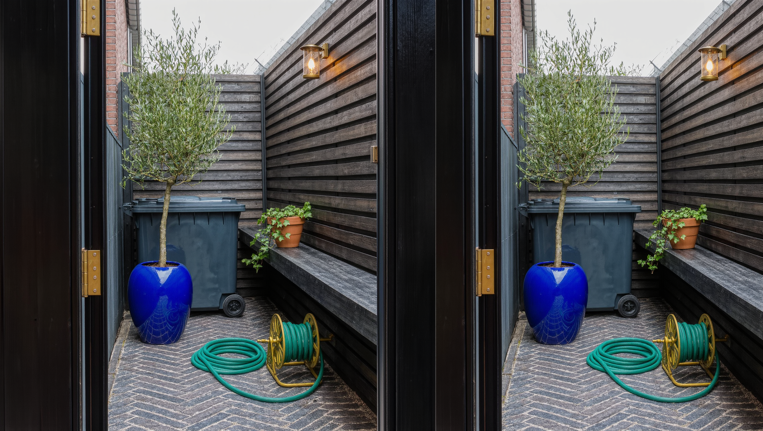 A narrow herringbone-brick side-yard passage with a wheeled bin discreetly tucked behind a brass-hinged timber screen, beside a glazed cobalt urn.